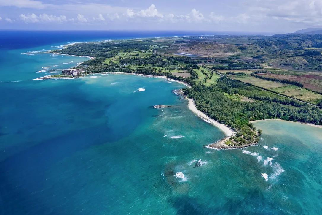 Aerial view of Kawela Bay and North Shore Oahu with turquoise ocean and coral reefs